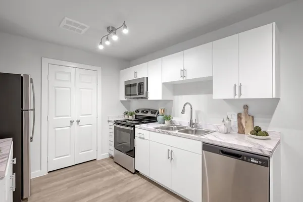 a kitchen with a sink stove and cabinets