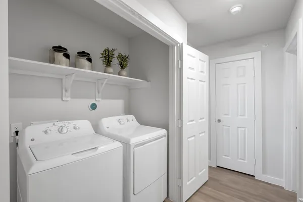a view of washer and dryer with wooden floor