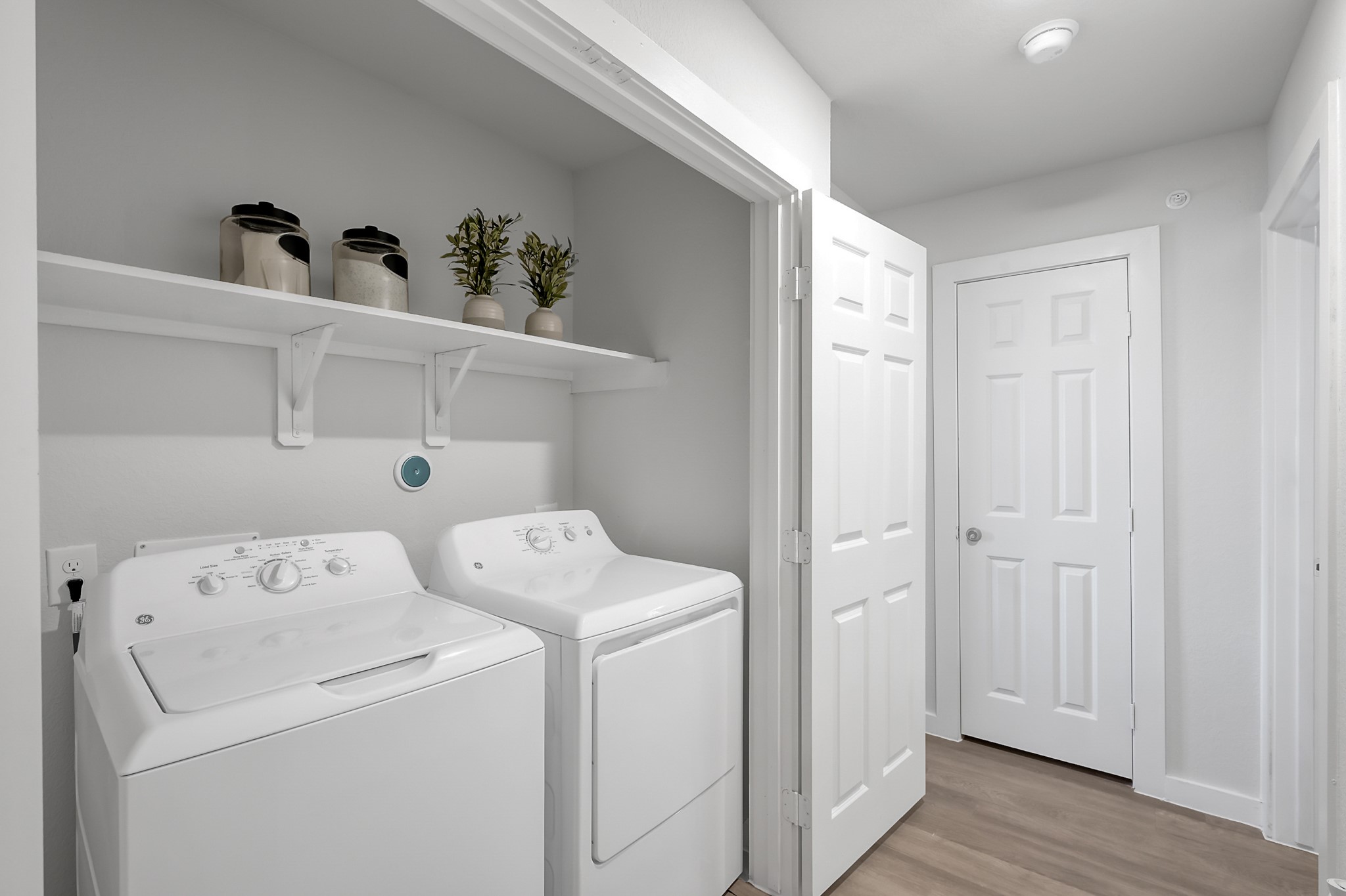3450 Barker Cypress Road, Unit 2205 Houston, TX 77084 - Photo 17 of 21 a view of washer and dryer with wooden floor