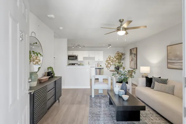 a living room with furniture and flowers