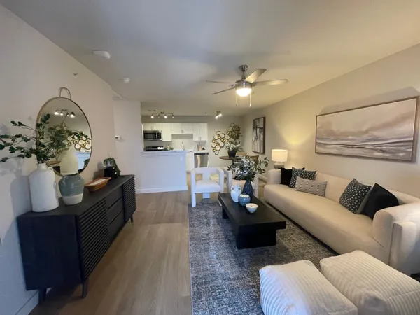 a living room with furniture and a chandelier