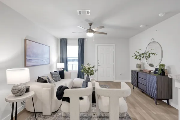 a living room with furniture and a chandelier