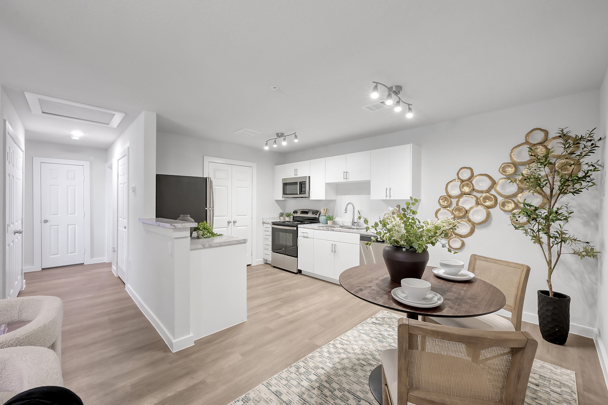 3450 Barker Cypress Road, Unit 2205 Houston, TX 77084 - Photo 6 of 21 a living room with furniture a potted plant and a flat screen tv