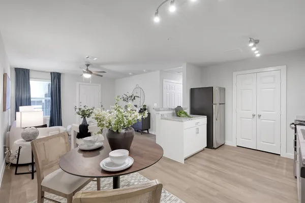 a dining room with furniture and wooden floor