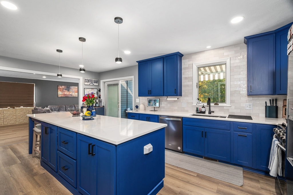 4 Horseneck Road Shrewsbury, MA 01545 - Photo 11 of 33 a kitchen with wooden cabinets a sink dishwasher and a stove with wooden floor