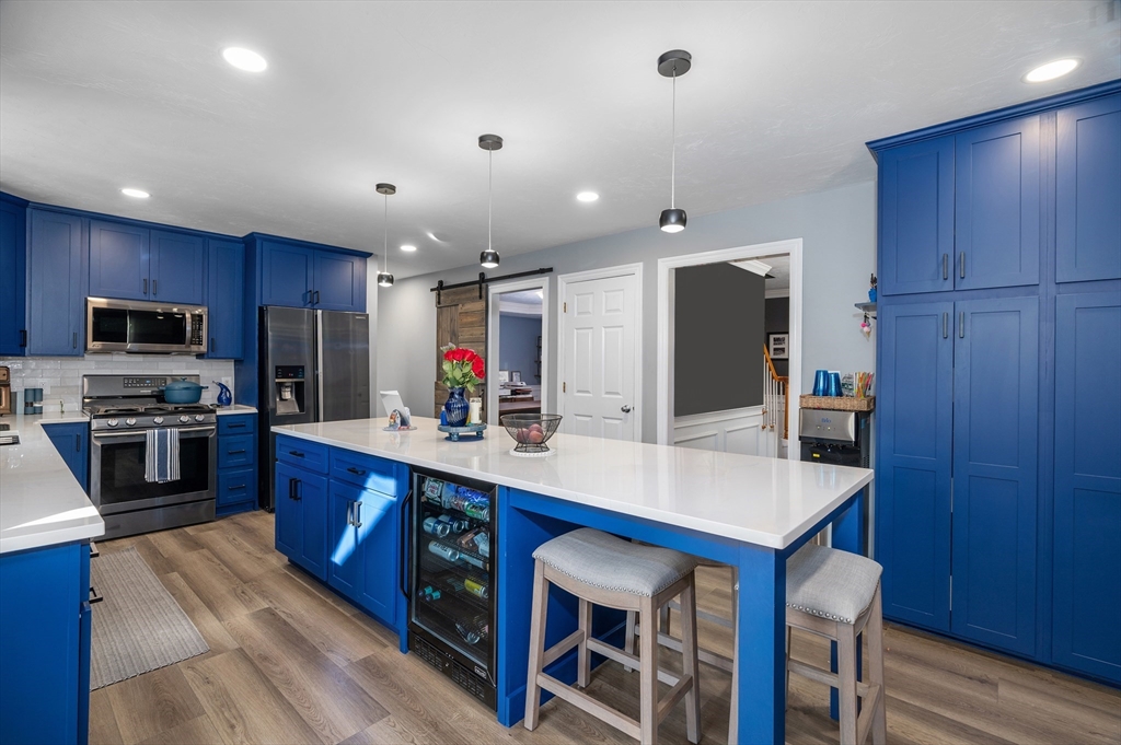 4 Horseneck Road Shrewsbury, MA 01545 - Photo 12 of 33 a kitchen with stainless steel appliances a sink a stove a microwave a center island and cabinets