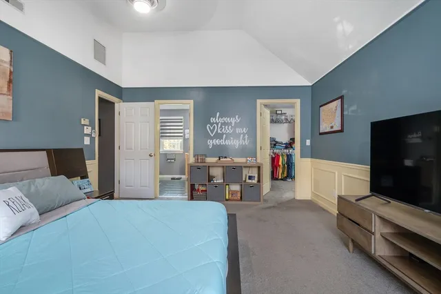 a bedroom with furniture and a flat screen tv