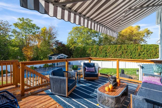 a view of balcony with wooden floor and outdoor seating