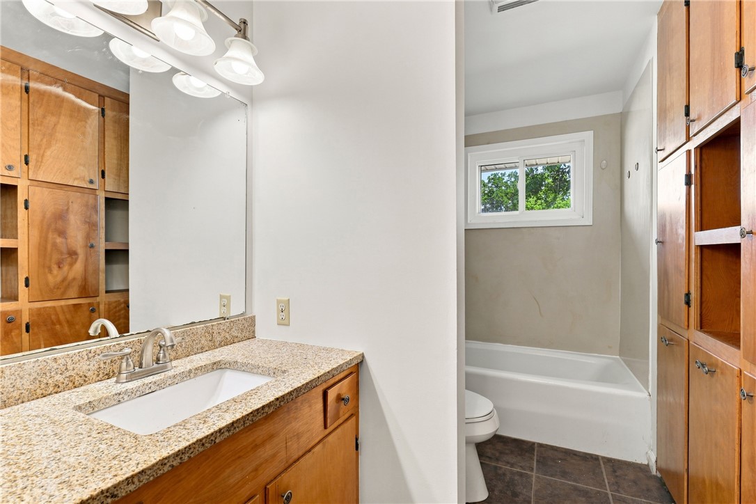 205 Timms Road Piedmont, SC 29673 - Photo 16 of 36 Rich wood cabinets and granite countertops define this functional bathroom layout.