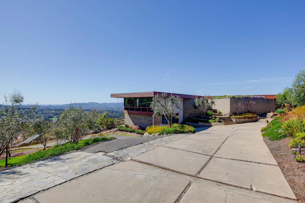 15480 Markar Road Poway, CA 92064 - Photo 1 of 1 a view of a patio with dining table and chairs with plants and big trees