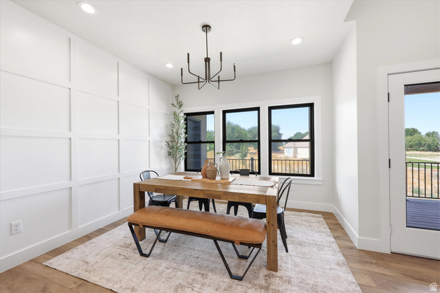 134 South Chamberlain Street Mapleton, UT 84664 - Photo 8 of 40 Board and batten accent wall, recessed ceiling lighting, wood-finish flooring, black window frames, and contemporary chandelier