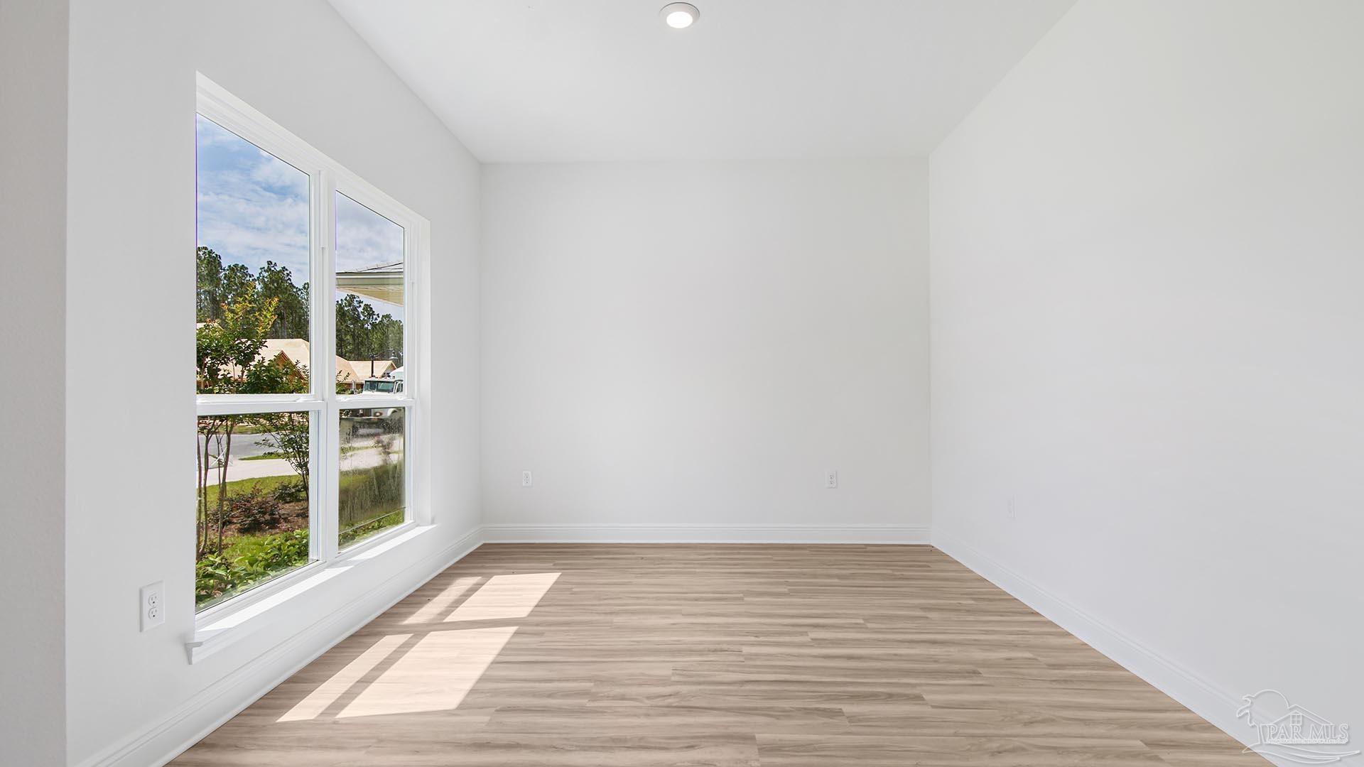 3233 Harrier Road Pace, FL 32571 - Photo 6 of 50 a view of empty room with wooden floor and fan