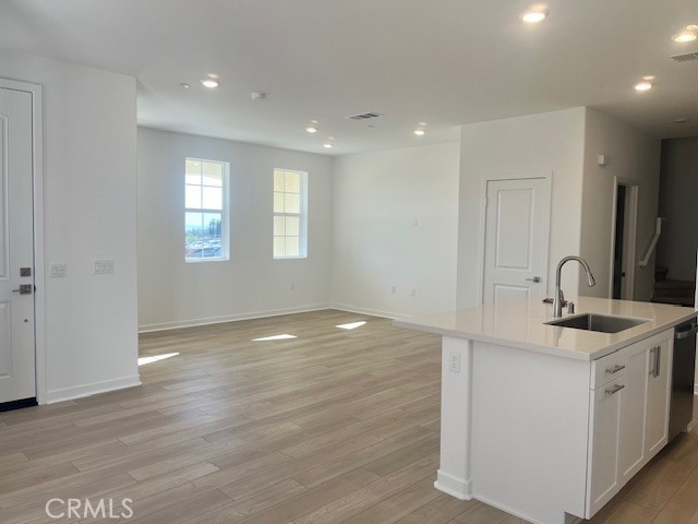 8421 Gabrielino Court Rancho Cucamonga, CA 91730 - Photo 2 of 8 a view of a kitchen cabinets a sink and dishwasher in it
