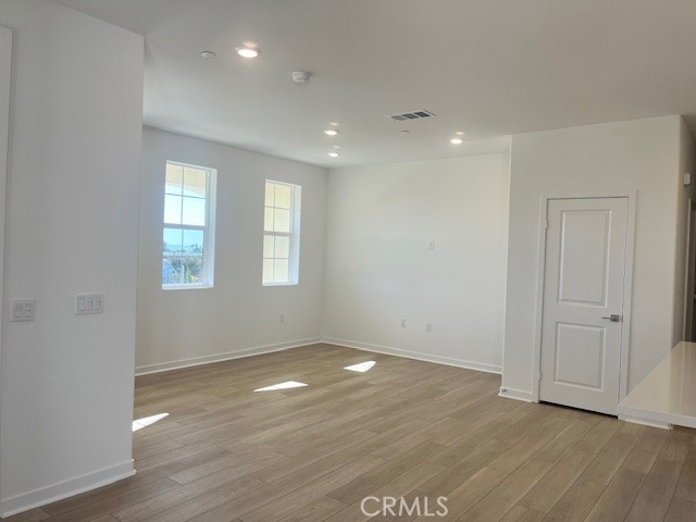8421 Gabrielino Court Rancho Cucamonga, CA 91730 - Photo 3 of 8 an empty room with wooden floor and windows