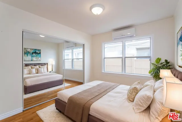 a bedroom with a large bed and a window