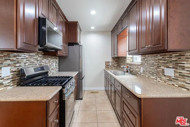 a kitchen that has a sink and a stove