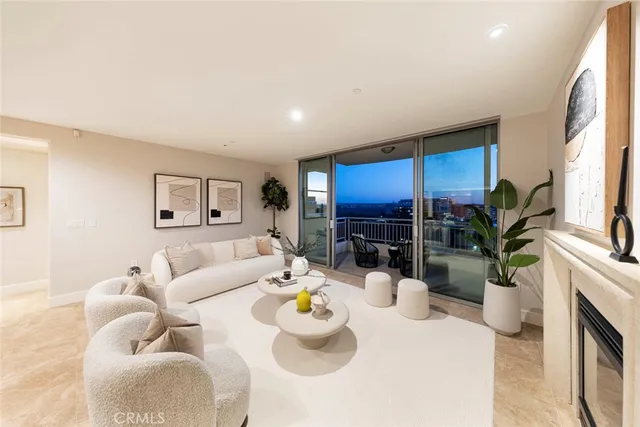 a living room with furniture a fireplace and a potted plant