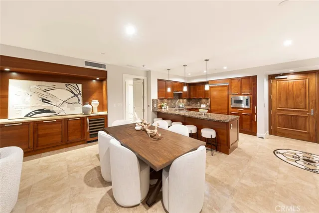 a dining room with furniture and a kitchen view