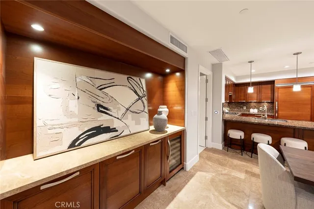 a kitchen with stainless steel appliances granite countertop a sink a stove and a refrigerator