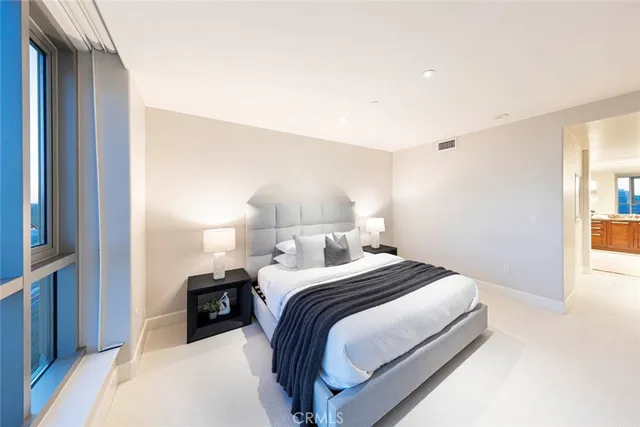 a bedroom with a bed and a lamp with window