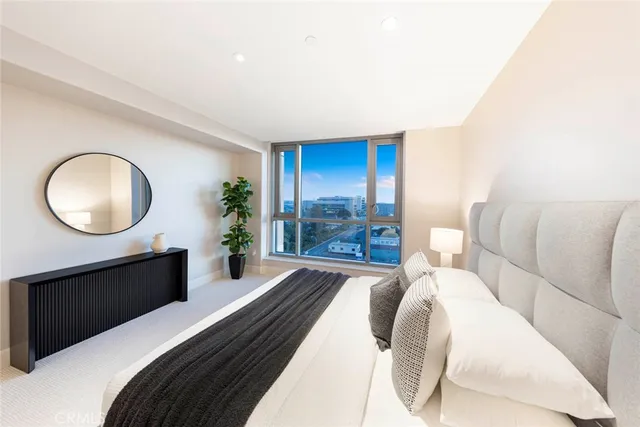 a bedroom with a bed and a mirror