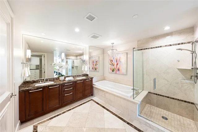 a spacious bathroom with a tub sink shower and mirror