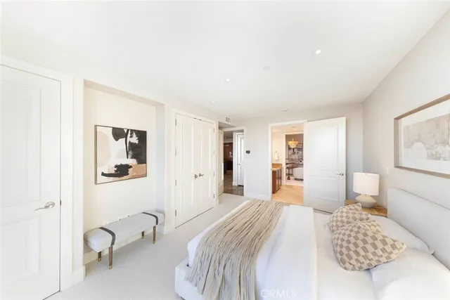 a bedroom with a bed and a night stand