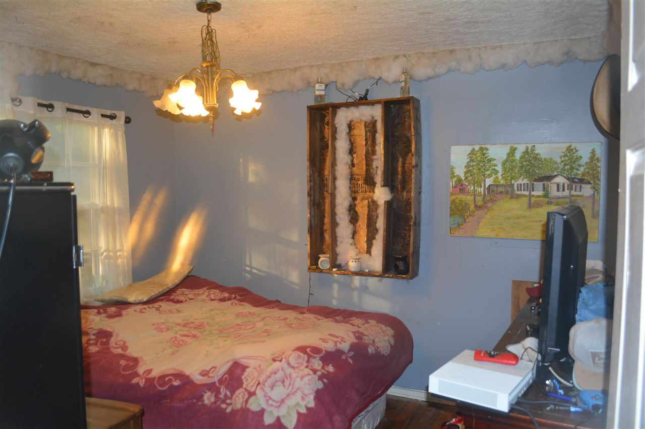 1292 Sweet Lips Road Finger, TN 38334 - Photo 4 of 15 a bedroom with a bed and a chandelier