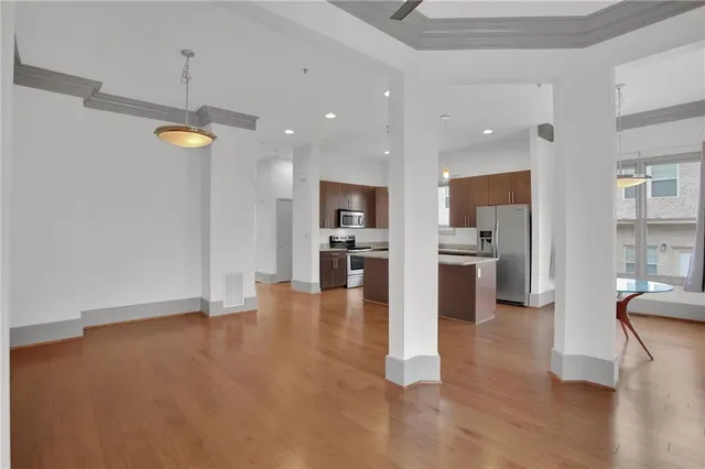 a view of kitchen with refrigerator and wooden floor