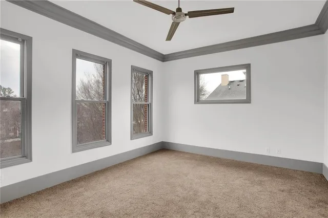 an empty room with windows and closet