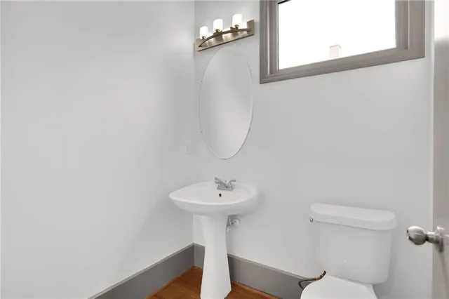 a bathroom with a sink a mirror and a toilet