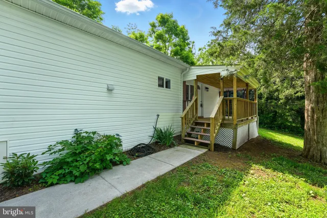 a view of a chair and table in backyard of the house