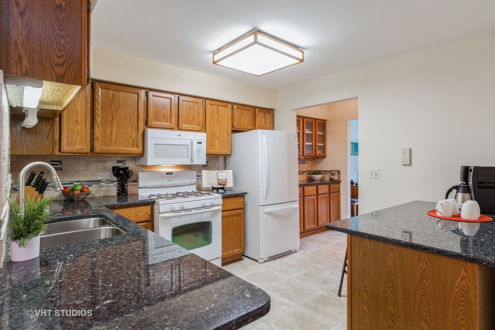 711 Bent Ridge Lane Elgin, IL 60120 - Photo 10 of 26 a kitchen with stainless steel appliances granite countertop a stove refrigerator and a sink with wooden floor