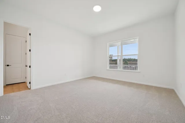 a spacious bathroom with a double vanity sink a mirror and a bathtub