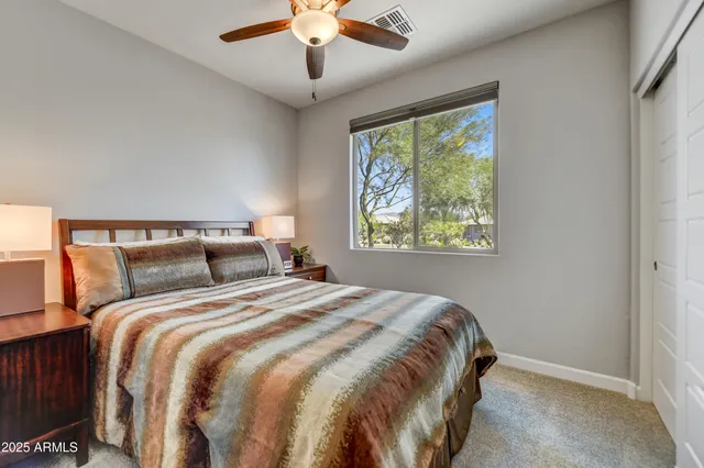 a bedroom with a large bed and a window