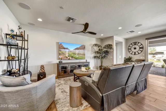 a living room with furniture a flat screen tv and a large window