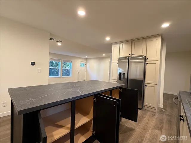 a kitchen with a stove and white cabinets