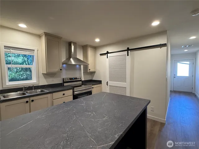 a kitchen with a stove and a refrigerator