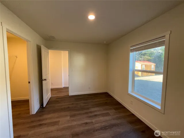 a backyard of a house with barbeque oven table and chairs