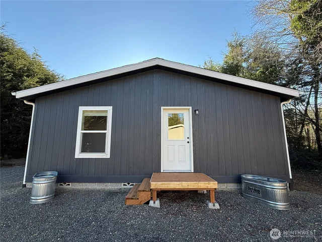 a front view of a house with a garden