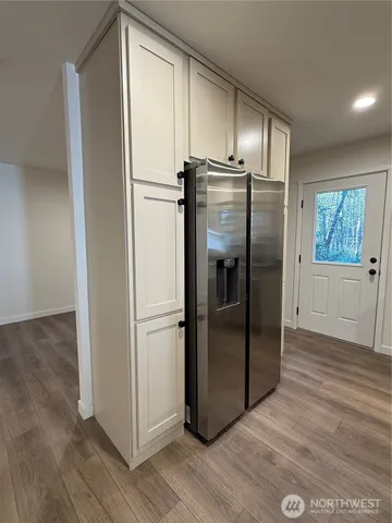 a metallic refrigerator freezer sitting in a kitchen