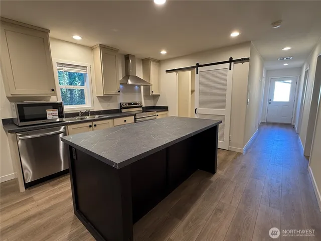 a kitchen with a sink stove and refrigerator