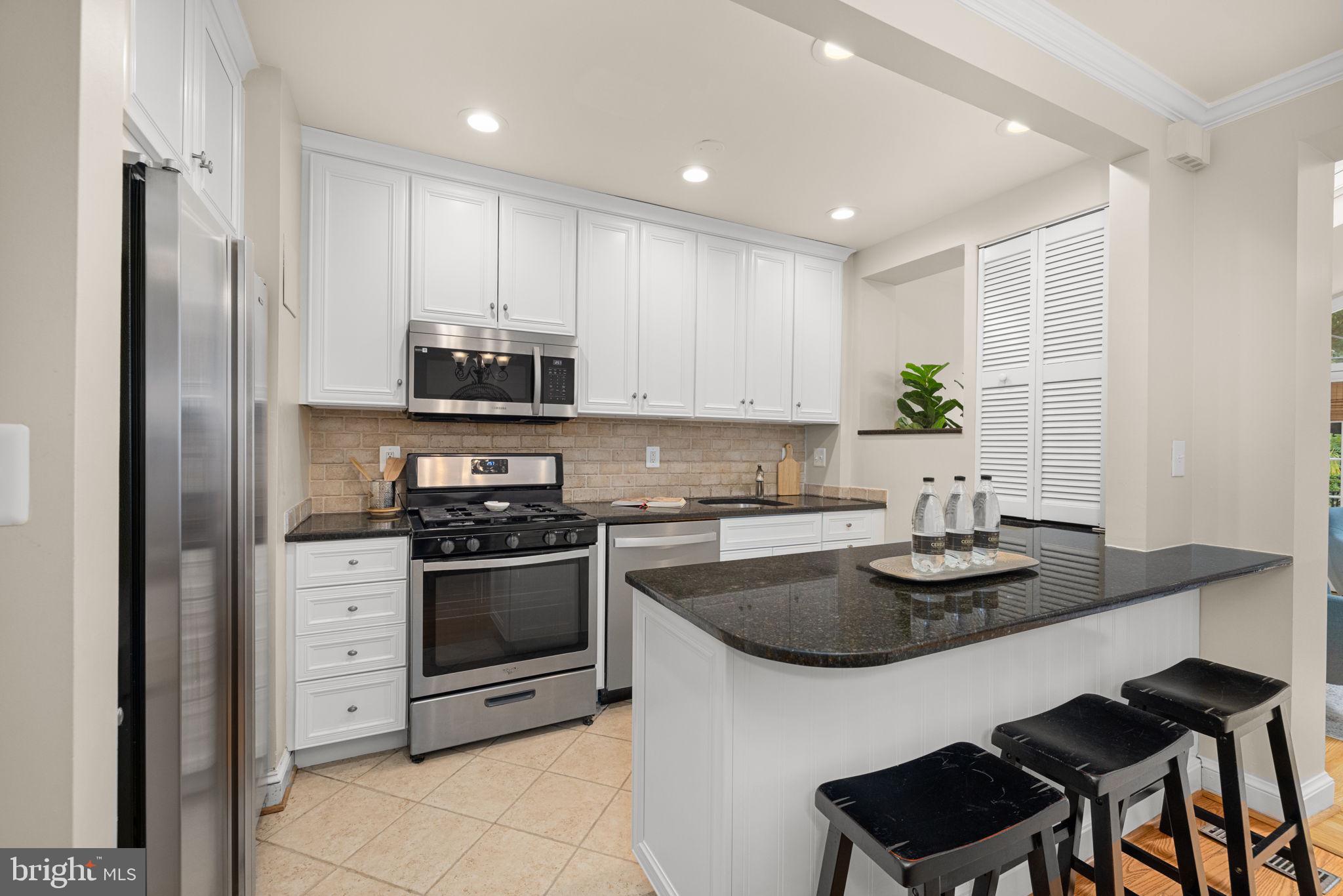 3762 W Street Northwest Washington, DC 20007 - Photo 13 of 41 a kitchen with sink cabinets and stainless steel appliances