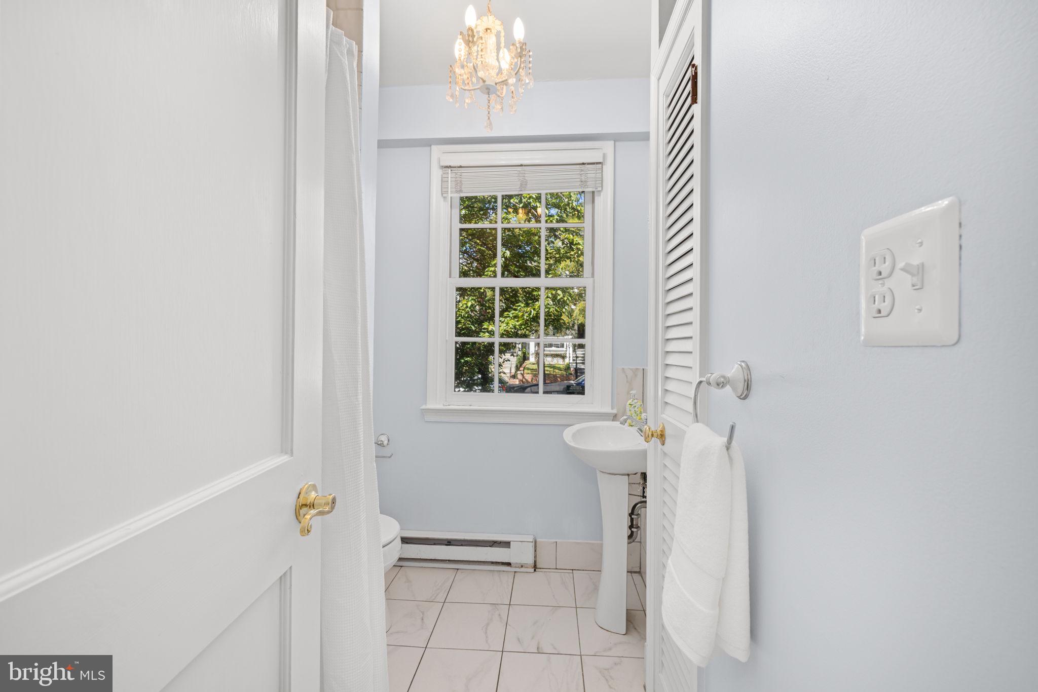 3762 W Street Northwest Washington, DC 20007 - Photo 19 of 41 a bathroom with a window and a shower