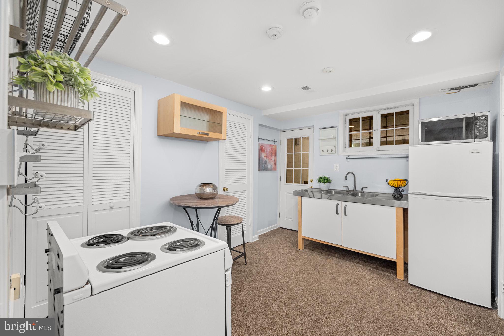 3762 W Street Northwest Washington, DC 20007 - Photo 32 of 41 a kitchen that has a sink and a stove