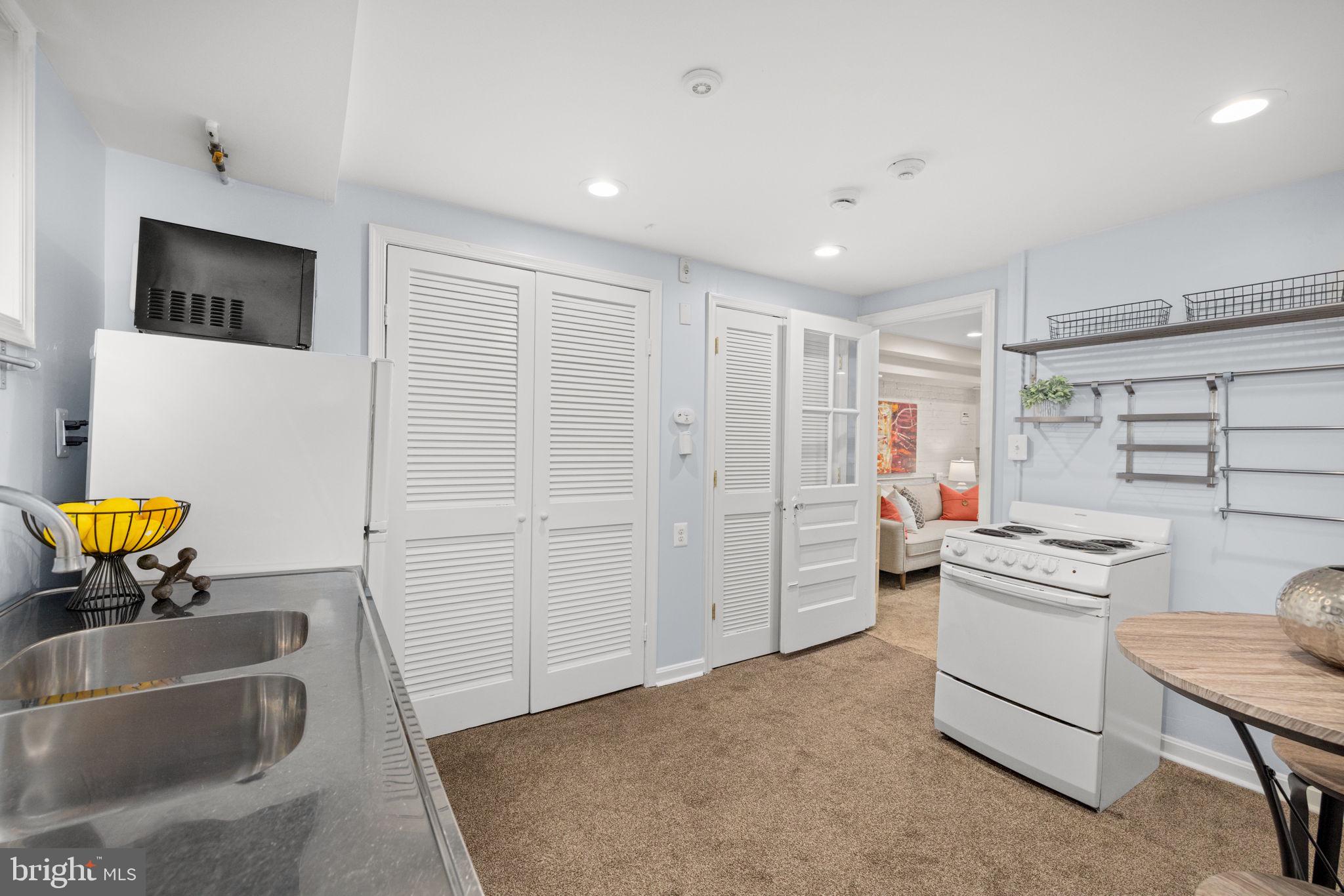3762 W Street Northwest Washington, DC 20007 - Photo 34 of 41 a kitchen with stainless steel appliances granite countertop a sink and a refrigerator