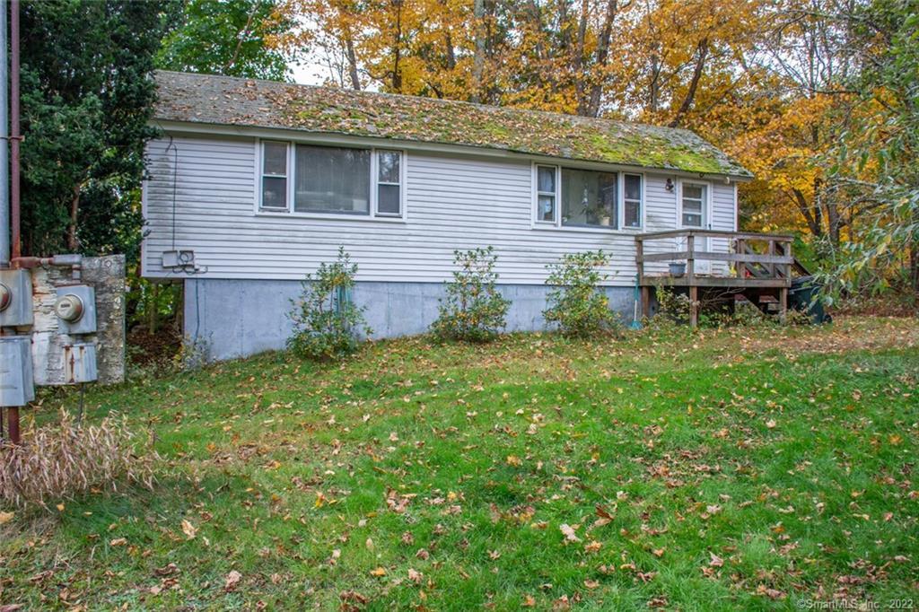 171 Snake Meadow Road Plainfield, CT 06354 - Photo 1 of 1 a backyard of a house with table and chairs