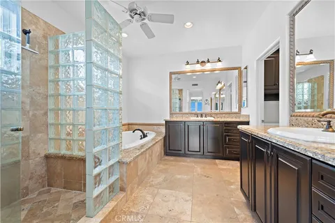 a spacious bathroom with a tub sink shower and mirror