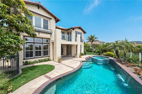 a front view of a house with a yard table and chairs