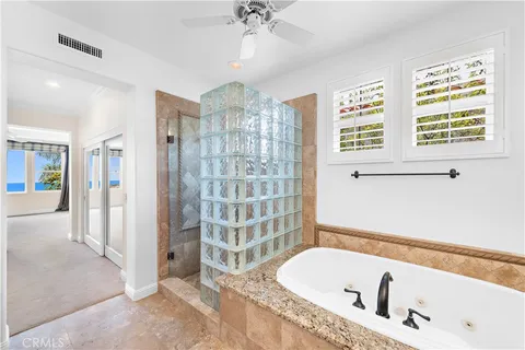 a bathroom with a tub a sink and a shower